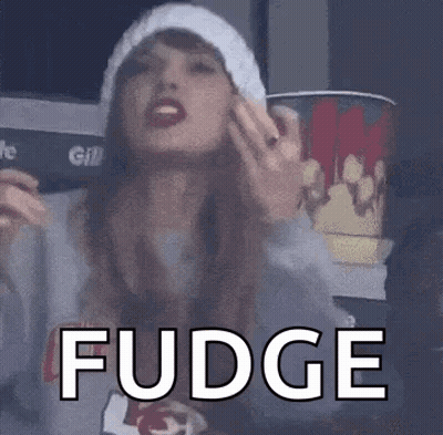 Woman In Hat And Sweater Holding Bucket Of Popcorn GIF