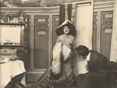 Woman In Hat Beside Man Black And White GIF
