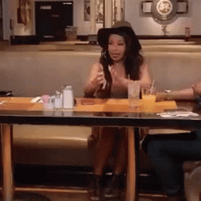 Woman In Hat Eating Sandwich At Restaurant GIF