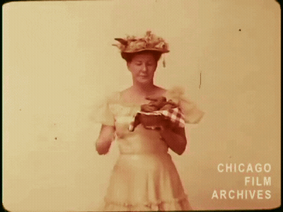 Woman In Hat Holding Dog GIF
