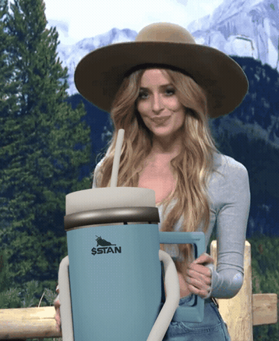 Woman In Hat Holding Giant Stan Mug With Straw GIF