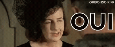 Woman In Hat Making Funny Face Oui GIF