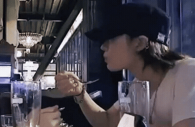 Woman In Hat Sitting At Table With Water And Fork GIF