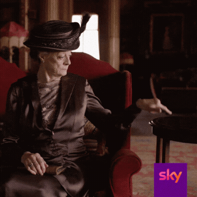 Woman In Hat Sitting In Red Chair With Sky Logo GIF