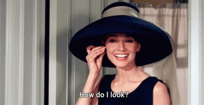Woman In Hat Smiling Asking How Do I Look GIF