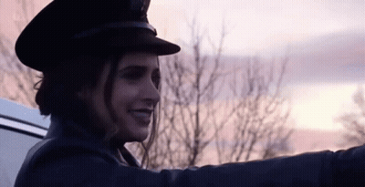 Woman In Hat Smiling In Back Of Car GIF