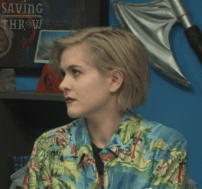 Woman In Hawaiian Shirt In Front Of Saving Throw Shelf GIF