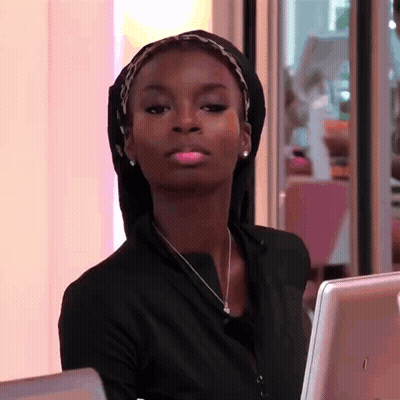 Woman In Head Scarf And Necklace At Computer GIF