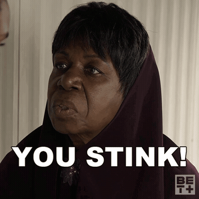 Woman In Head Scarf Saying You Stink GIF