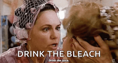 Woman In Head Scarf Talking And Drinking Bleach GIF