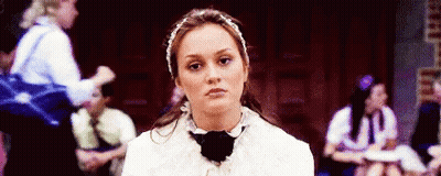 Woman In Headband And Bow Tie Sitting With Group GIF