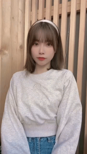 Woman In Headband And Grey Sweatshirt GIF
