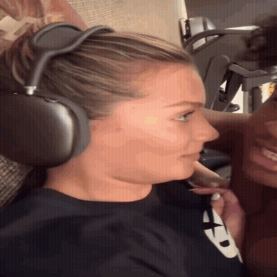 Woman in Headphones and Black Shirt with X