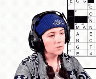 Woman In Headphones And Blue Hat Saying Soy Fanta With Crossword Puzzle GIF