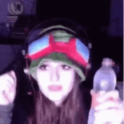 Woman In Headphones And Goggles Holding Water Bottle GIF