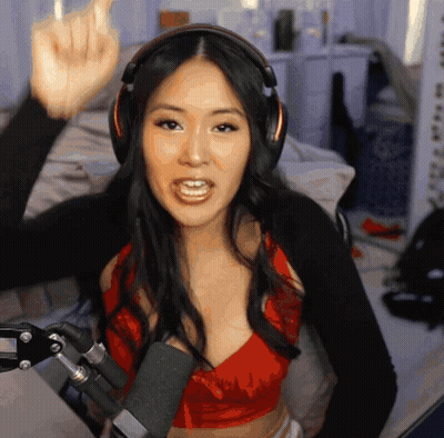 Woman In Headphones And Red Top Giving Middle Finger At Microphone GIF