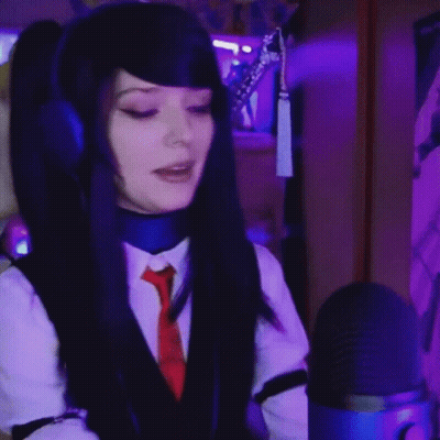 Woman In Headphones And Tie Singing Into Blue Microphone GIF