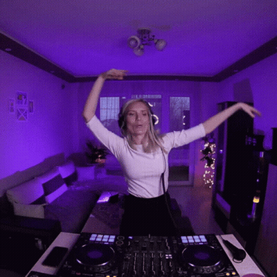 Woman In Headphones And White Shirt At DJ Controller GIF