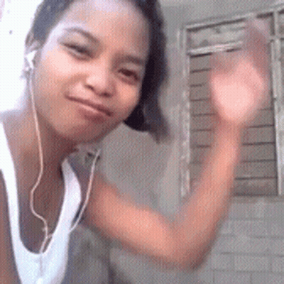 Woman In Headphones And White Tank Top Waving GIF