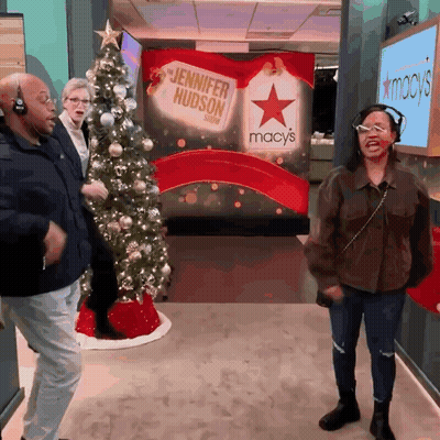 Woman In Headphones Dancing In Front Of Jennifer Hudson Sign GIF