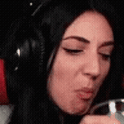 Woman In Headphones Drinking From Glass Making Face GIF