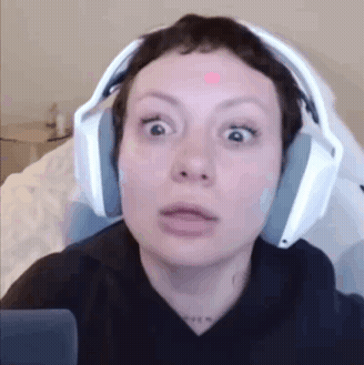Woman In Headphones Making Funny Face Sitting In Chair GIF
