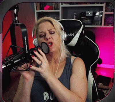 Woman In Headphones Singing Into Microphone With WN On Chair GIF