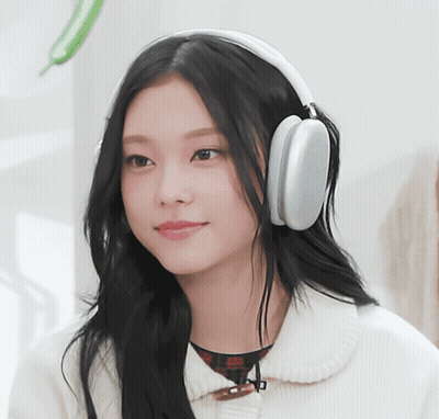 Woman In Headphones Smiling At Camera GIF