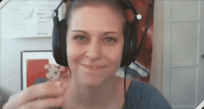 Woman In Headphones Smiling With Stuffed Animal GIF