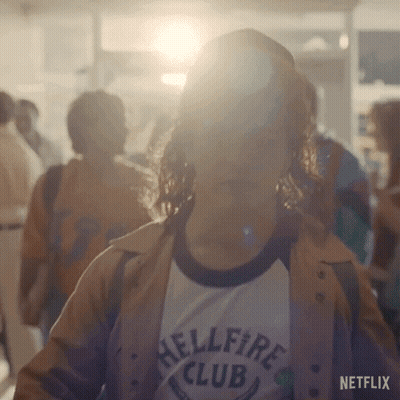 Woman In Hellfire Club T-Shirt Standing In Crowd GIF
