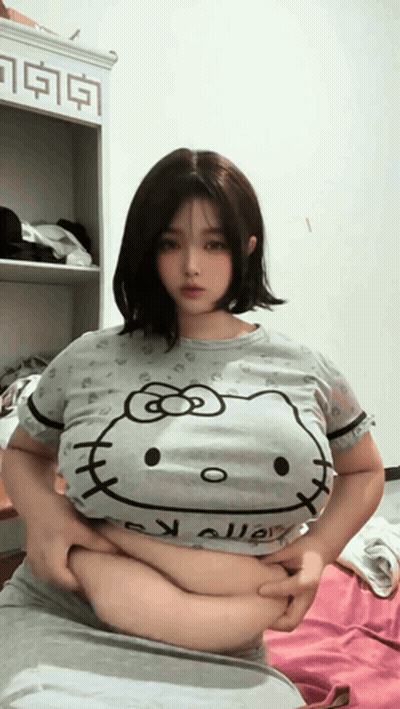 Woman In Hello Kitty T-Shirt Holding Belly GIF