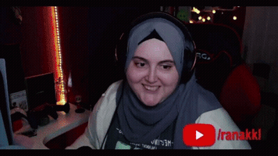 Woman in Hijab and Headphones Smiling at Iranakikiclips Screen