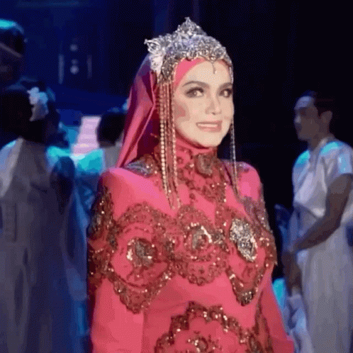 Woman In Hijab And Pink Dress Standing On Stage GIF