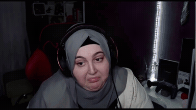 Woman In Hijab Wearing Headphones Making Face GIF