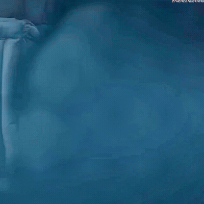 Woman In Hooded Jacket Looking At Camera GIF