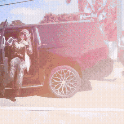Woman In Hooded Jacket Sitting In Black SUV GIF