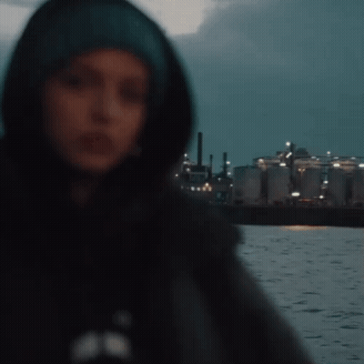 Woman In Hooded Jacket Standing Before Water GIF