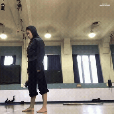 Woman In Hooded Jacket Standing In Front Of Mirror Saying Awesome GIF