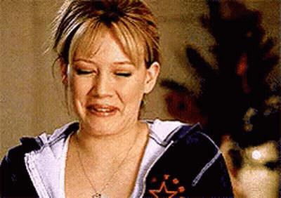 Woman In Hoodie And Necklace Making Funny Face GIF