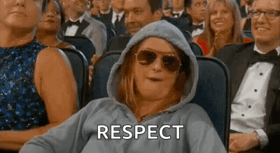 Woman In Hoodie And Sunglasses Watching Movie In Crowd GIF