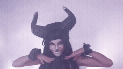 Woman In Horned Hat Making Funny Face GIF