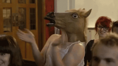 Woman In Horse Mask Waving At Group GIF