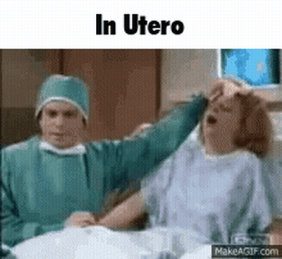 Woman In Hospital Bed With Doctor Holding Her Head GIF