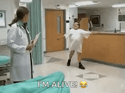 Woman In Hospital Gown Dancing As Doctor Looks On GIF