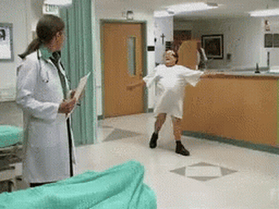 Woman In Hospital Gown Dancing Before Doctor Holding Clipboard GIF