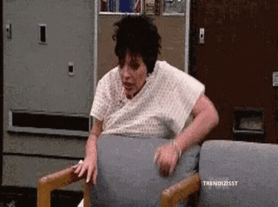 Woman In Hospital Gown Sitting GIF