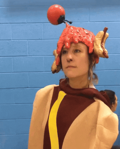 Woman In Hot Dog Costume With Red Ball On Head GIF