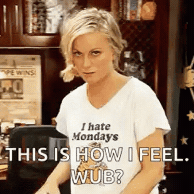 Woman In I Hate Mondays Shirt Standing At Desk GIF