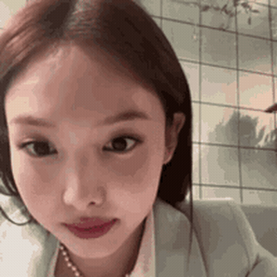 Woman In Jacket And Pearl Necklace GIF