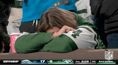 Woman In Jets Jersey Covering Face While Watching Game GIF